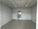 Empty room with tiled floor and recessed lighting