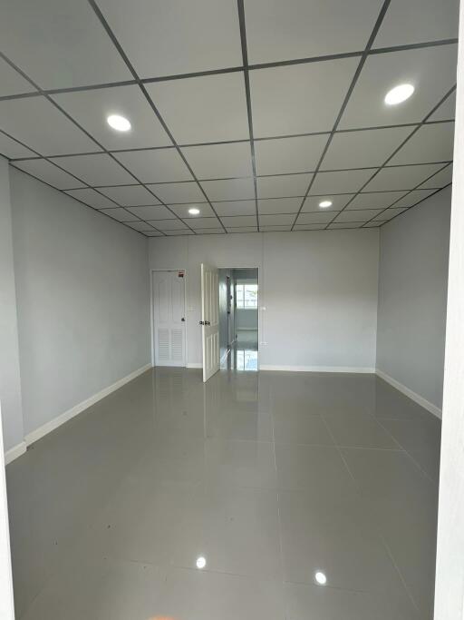 Empty room with tiled floor and recessed lighting