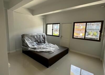 Sleek and modern bedroom with a covered bed