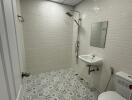 Modern bathroom with tiled walls and floor, shower, sink, and toilet