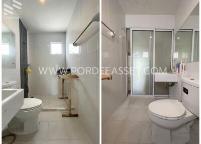 Modern bathroom with large mirror, white tiles, and glass shower partition