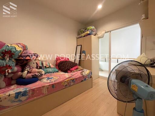 Bedroom with colorful bedding and plush toys