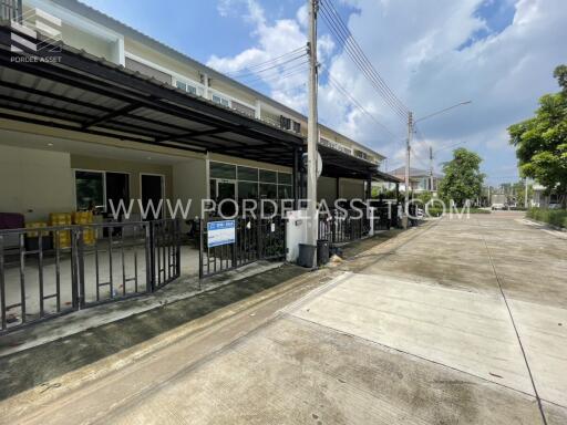 Apartment complex exterior with empty driveway