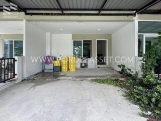 Covered garage area next to the entrance of the house