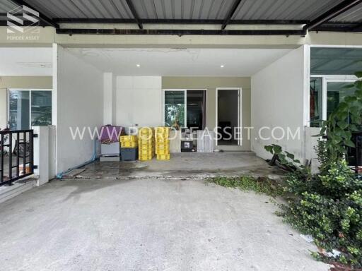 Covered garage area next to the entrance of the house