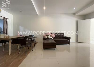 Spacious and modern living room with sofa and dining area