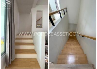 Modern wooden staircase with handrail and window