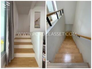 Modern wooden staircase with handrail and window