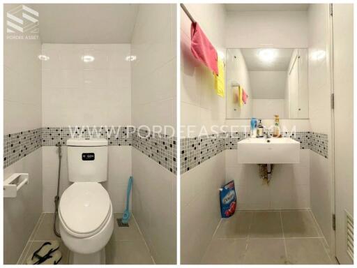 Bathroom with tiled walls, toilet, and sink