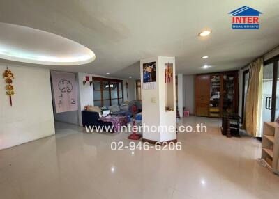 Spacious living room with tiled floor and modern lighting