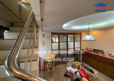 Living room with staircase and storage area