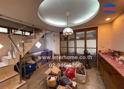 Living room with staircase and skylight