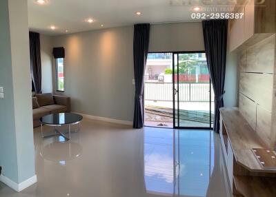 Modern living room with large window and built-in shelving