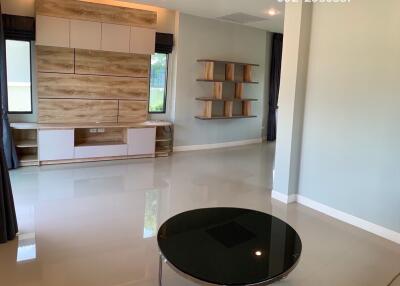 Spacious modern living room with built-in shelving and large windows