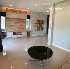 Spacious modern living room with built-in shelving and large windows