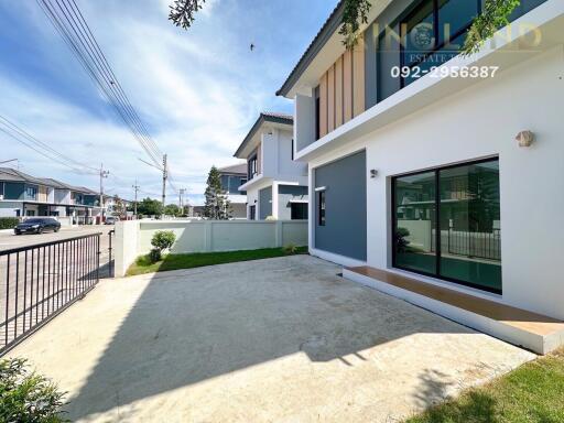 Modern residential building exterior with yard