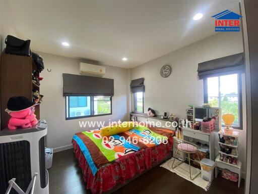 Cozy bedroom with colorful bedding, shelves, and windows