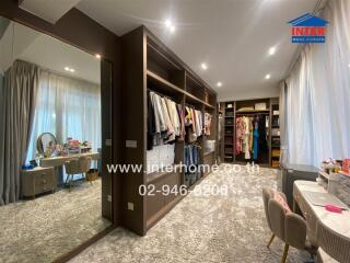 Spacious bedroom with walk-in closet and vanity area