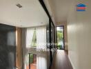 Modern hallway in a building with large windows and natural light