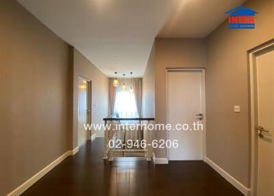 Spacious hallway with modern lighting and wooden flooring