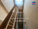 Indoor staircase with wooden steps and white railing