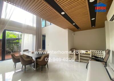 Spacious and brightly lit dining room with modern furniture and high ceiling