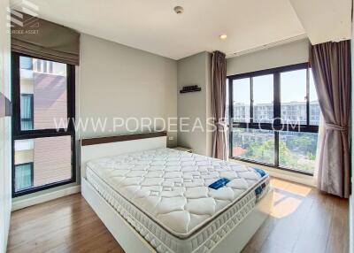 Modern bedroom with large windows and a new mattress