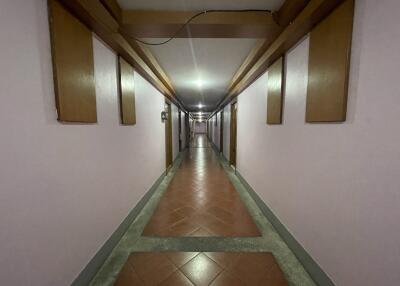 long hallway in a building with tiled floor