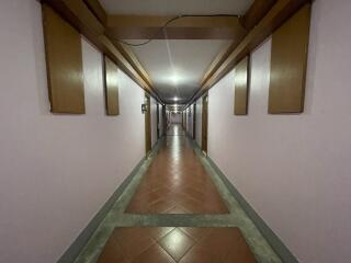 long hallway in a building with tiled floor