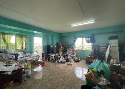 Bedroom with cluttered furniture and belongings