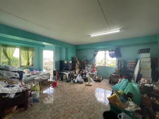 Bedroom with cluttered furniture and belongings