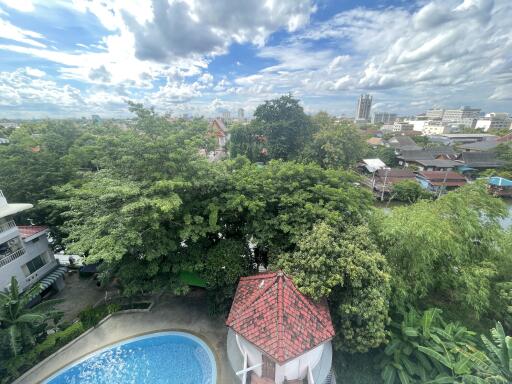 Aerial view of a property with a swimming pool and lush greenery