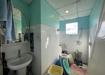 Bathroom with sink, mirror, and shower area