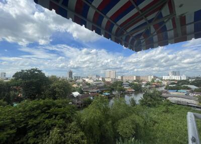 View from balcony with a cityscape and greenery