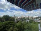 View from balcony with a cityscape and greenery