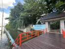 Entrance of a property with surrounding greenery and a water body