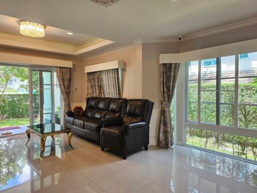 Spacious living room with large windows and leather sofa