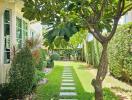 Well-maintained garden with stone pathway and lush greenery