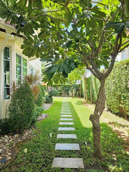 Well-maintained garden with stone pathway and lush greenery