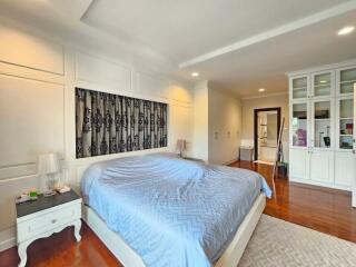 spacious bedroom with large bed and white cabinetry