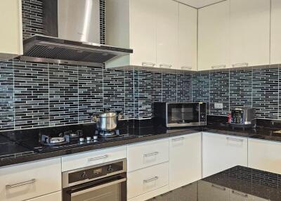 Modern kitchen with stainless steel appliances and black countertop