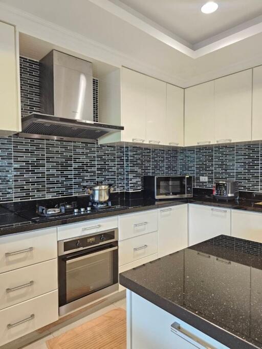 Modern kitchen with stainless steel appliances and black countertop