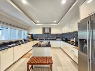 Modern kitchen with white cabinetry and black countertops