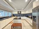 Modern kitchen with white cabinetry and black countertops