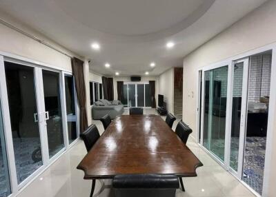 Spacious dining room with a wooden table and dark chairs