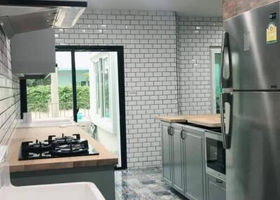 Modern kitchen with stainless steel appliances and colorful tiled floor