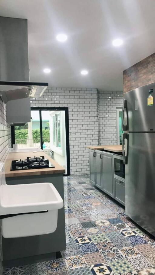 Modern kitchen with white subway tile backsplash and patterned floor tiles