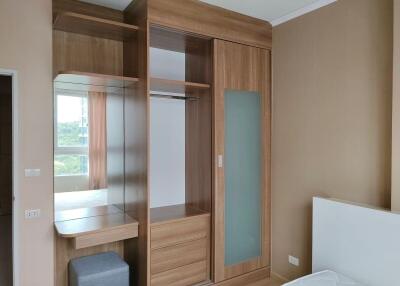 Spacious bedroom with built-in wooden wardrobe and natural light