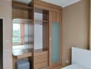 Spacious bedroom with built-in wooden wardrobe and natural light