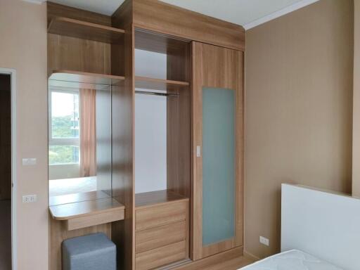 Spacious bedroom with built-in wooden wardrobe and natural light